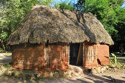 While the wealthy of socially prominent may have had adobe homes, the most common house structure in Central America was that of a thatched-roof hut. Image via Adobe Stock.