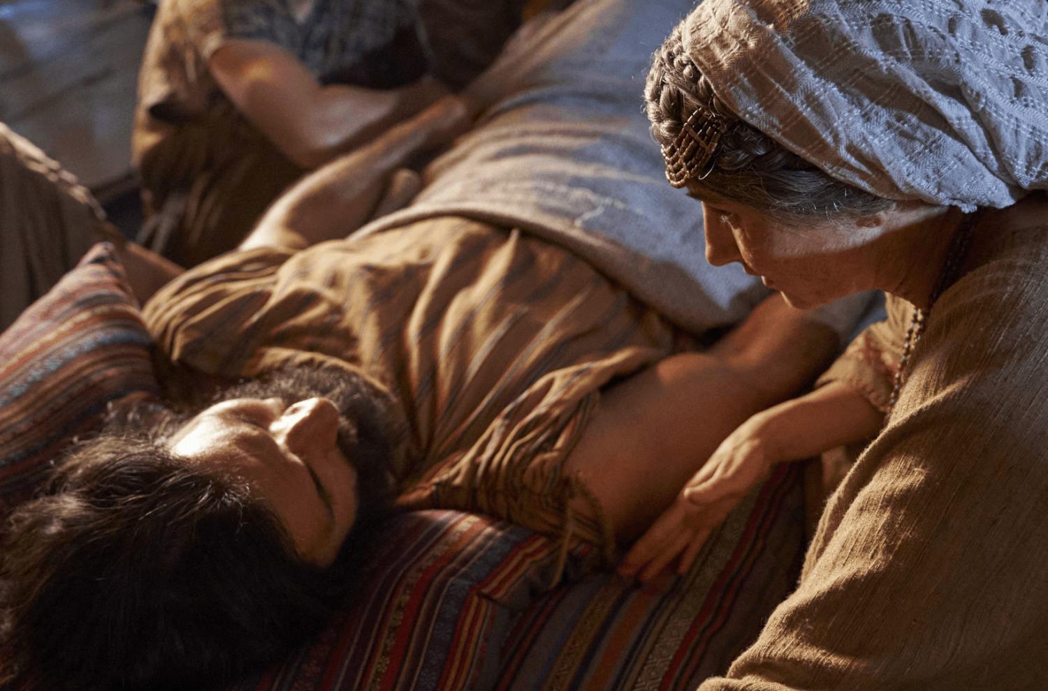 The mother of Alma the Younger watches over him while he sleeps in this image from the Book of Mormon Videos of The Church of Jesus Christ of Latter-day Saints.