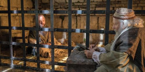 Paul dictates a letter from a jail cell. Image from Bible Videos of The Church of Jesus Christ of Latter-day Saints.